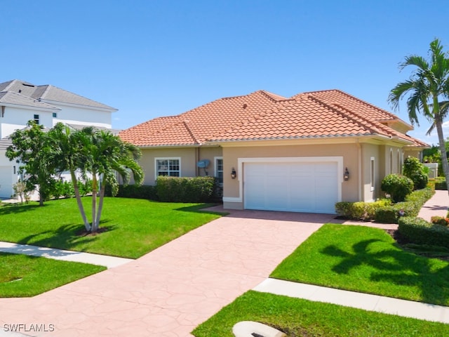 mediterranean / spanish-style house featuring a front lawn and a garage