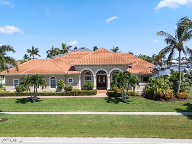 mediterranean / spanish house with a front yard