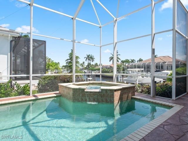 view of pool with a lanai and an in ground hot tub