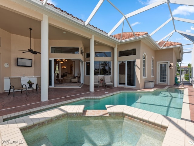 view of swimming pool featuring ceiling fan, a patio area, and a lanai