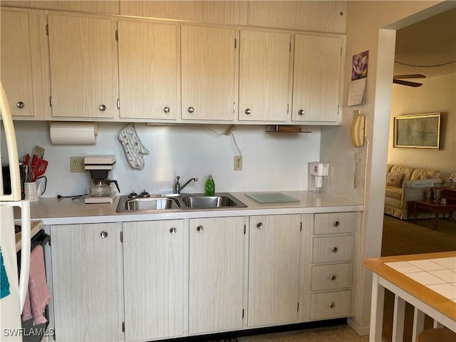 kitchen featuring sink, ceiling fan, and light brown cabinets