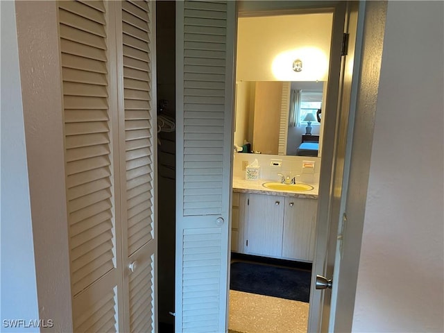 bathroom featuring tasteful backsplash and vanity