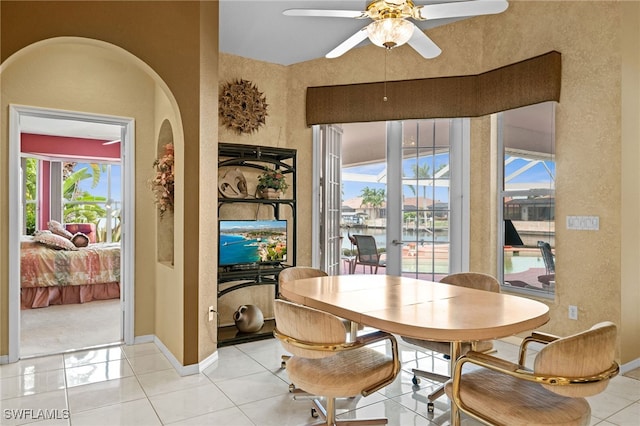 tiled dining space featuring ceiling fan