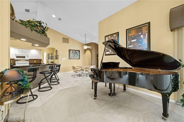 2512 SW 28th Pl, Cape Coral, FL 33914 - sitting room with arched walkways, ceiling fan, baseboards, light tile patterned flooring, and high vaulted ceiling