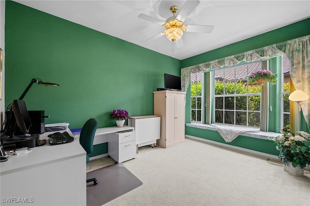 carpeted office space with ceiling fan