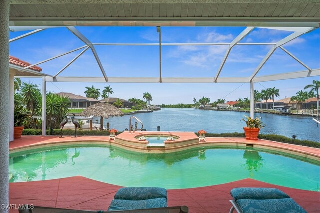 view of swimming pool featuring glass enclosure, a water view, an in ground hot tub, and a patio