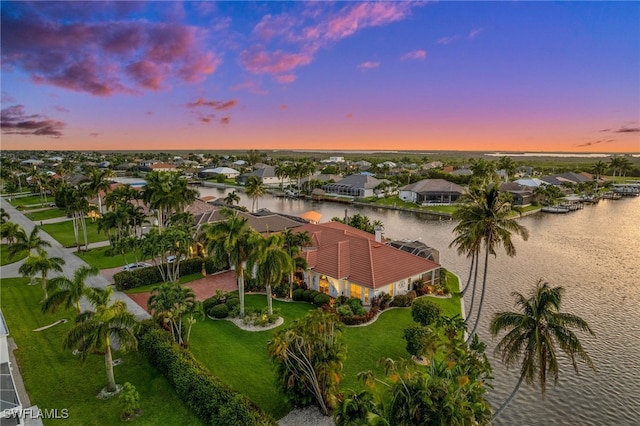 aerial view at dusk with a water view