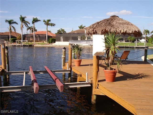 view of dock featuring a gazebo and a water view