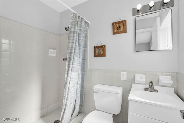 bathroom with vanity, toilet, walk in shower, and tile walls