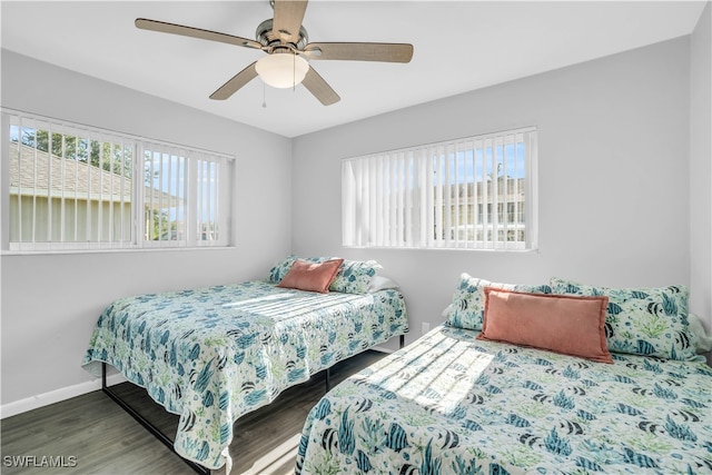 bedroom featuring dark hardwood / wood-style flooring and ceiling fan