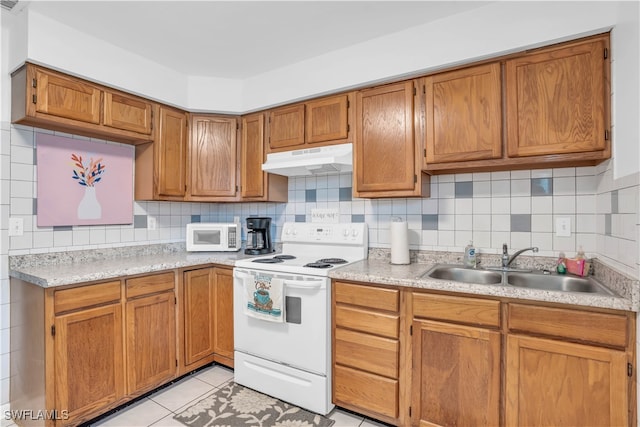 kitchen featuring decorative backsplash, light tile patterned flooring, white appliances, and sink