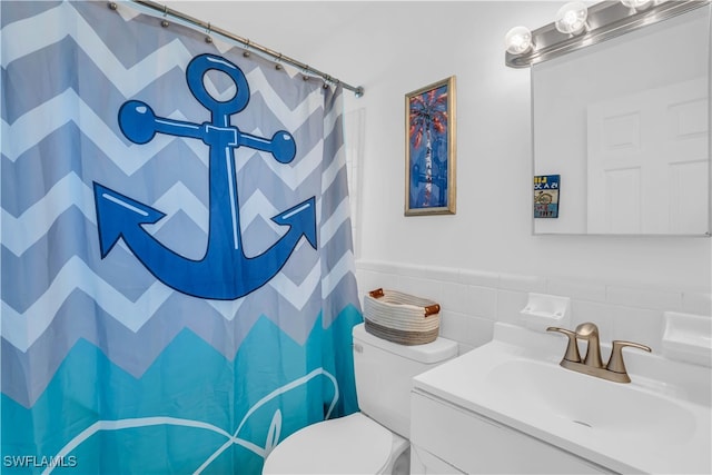 bathroom featuring tile walls, tasteful backsplash, toilet, and vanity