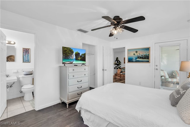 bedroom featuring sink, connected bathroom, ceiling fan, and dark hardwood / wood-style floors