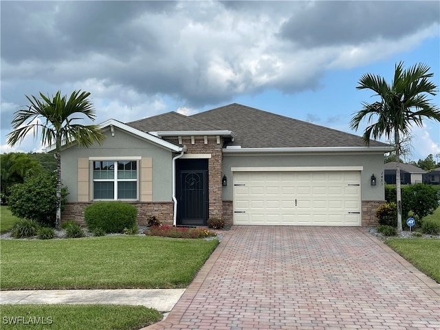 view of front of home featuring a garage and a front yard