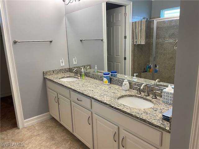 bathroom with tile patterned flooring, a shower with door, and vanity