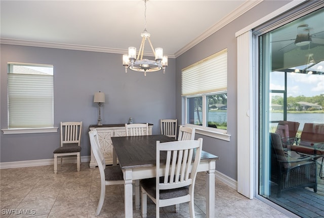 tiled dining area with a water view, ceiling fan with notable chandelier, plenty of natural light, and crown molding