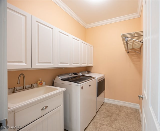 laundry area with washer and clothes dryer, sink, light tile patterned flooring, crown molding, and cabinets