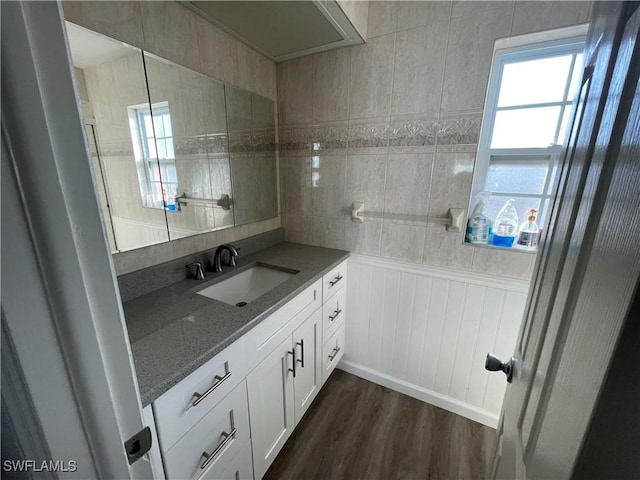 bathroom with a healthy amount of sunlight, vanity, and wood finished floors