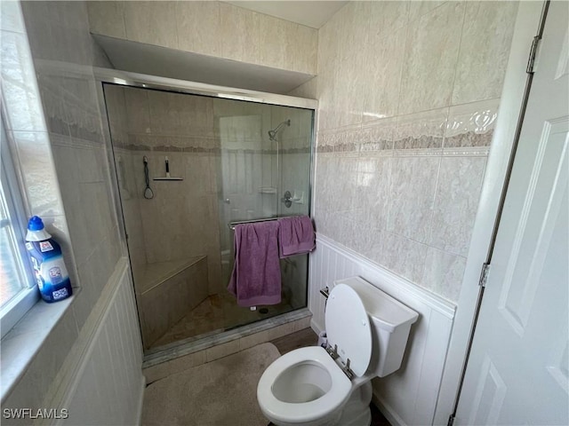 bathroom with a shower stall and toilet