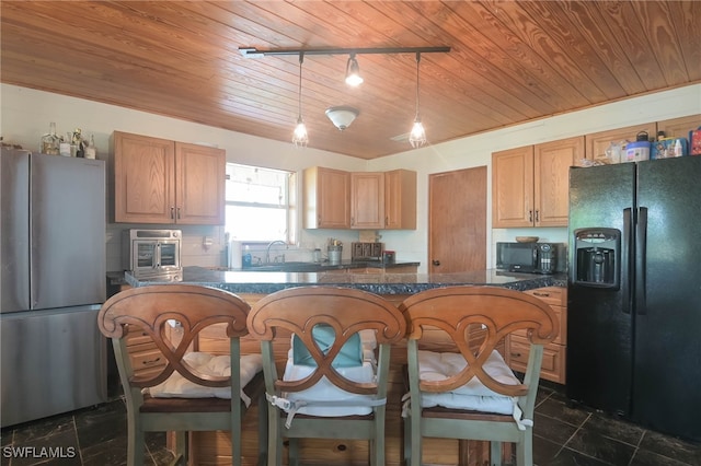 kitchen with pendant lighting, sink, dark tile patterned floors, wooden ceiling, and black appliances