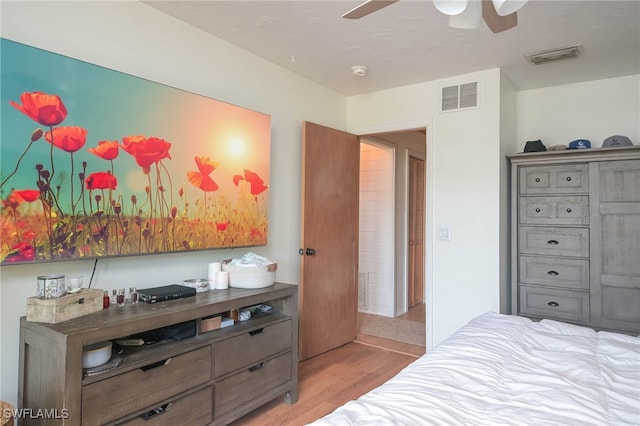 bedroom with ceiling fan and light hardwood / wood-style flooring