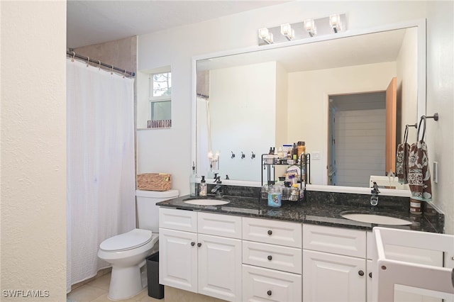 bathroom with dual vanity, toilet, and tile patterned flooring