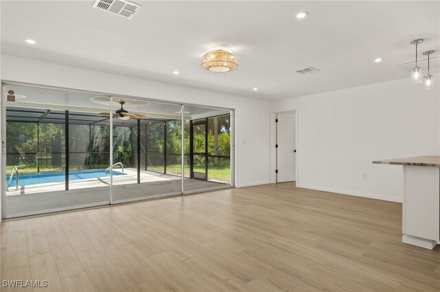 empty room featuring light hardwood / wood-style flooring and ceiling fan