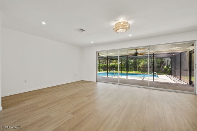 empty room featuring ceiling fan, light hardwood / wood-style floors, and a healthy amount of sunlight