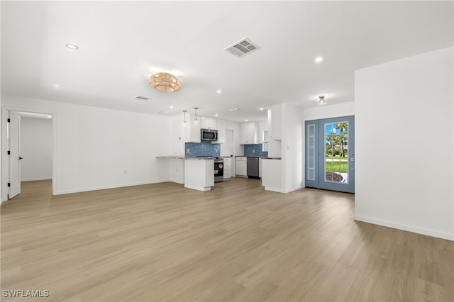 unfurnished living room with light wood-type flooring