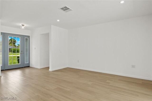 spare room with light hardwood / wood-style flooring