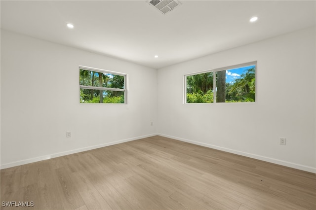 unfurnished room with light hardwood / wood-style floors and a wealth of natural light