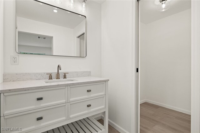 bathroom with vanity and hardwood / wood-style flooring