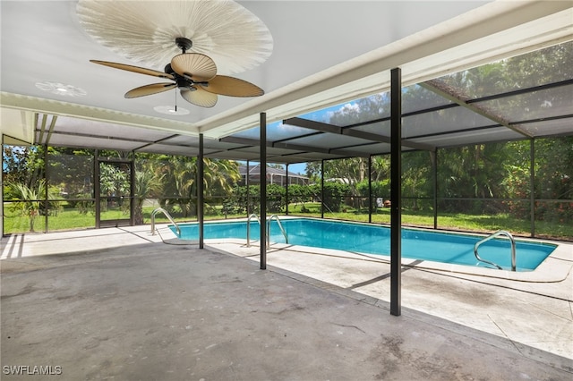 view of pool with a lanai, a patio, and ceiling fan