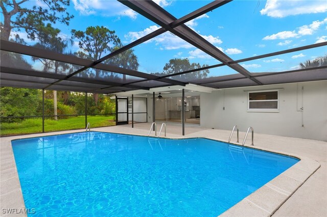 view of swimming pool featuring a lanai and a patio