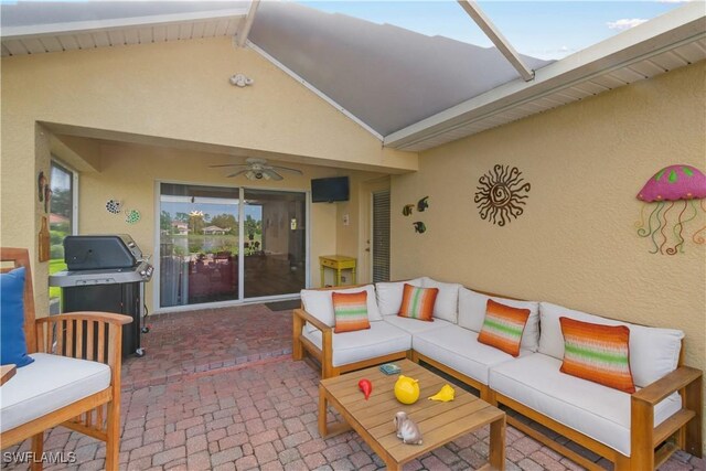 view of patio featuring glass enclosure, a grill, ceiling fan, and outdoor lounge area