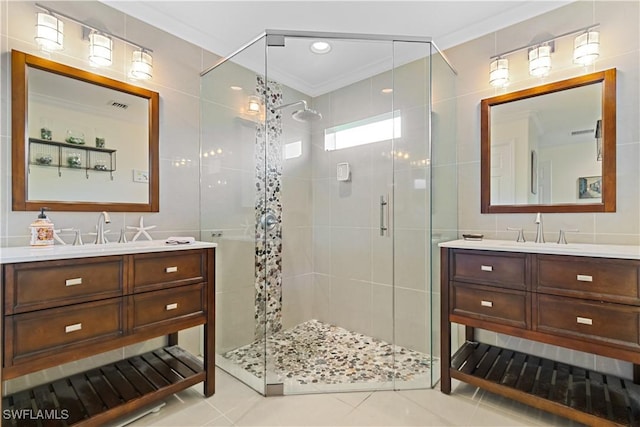 bathroom with a shower with door, tile walls, tile patterned flooring, vanity, and ornamental molding