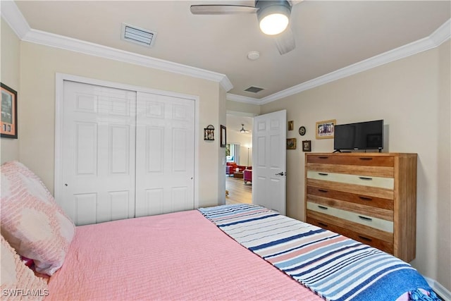 bedroom with visible vents, a closet, and crown molding