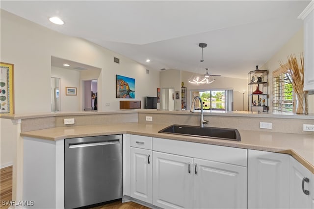 kitchen with dishwasher, sink, hardwood / wood-style floors, white cabinetry, and lofted ceiling