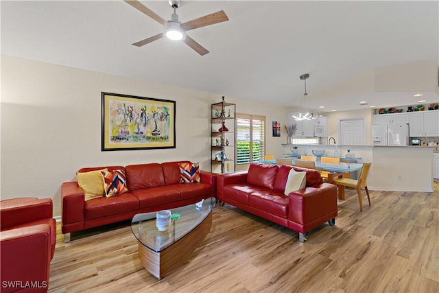 living room featuring ceiling fan and light wood-type flooring