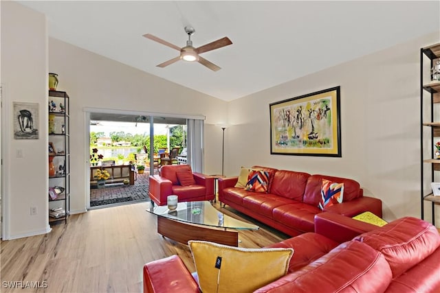 living area with wood finished floors, a ceiling fan, and vaulted ceiling