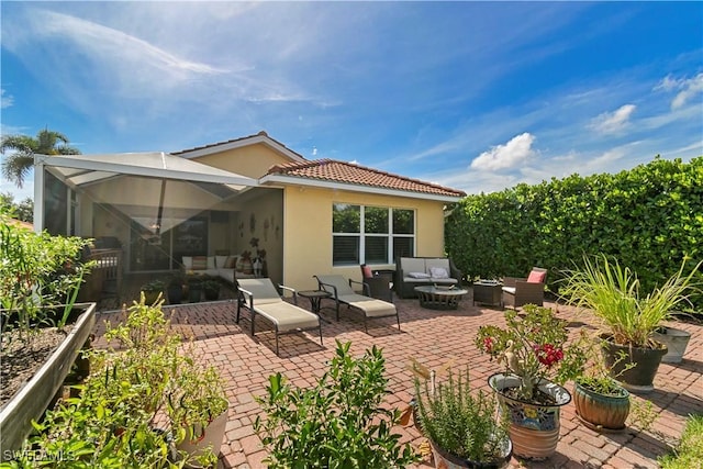 rear view of property with a lanai, an outdoor living space, a patio, and stucco siding