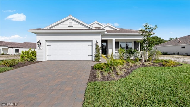 view of front of property featuring a garage and a front lawn