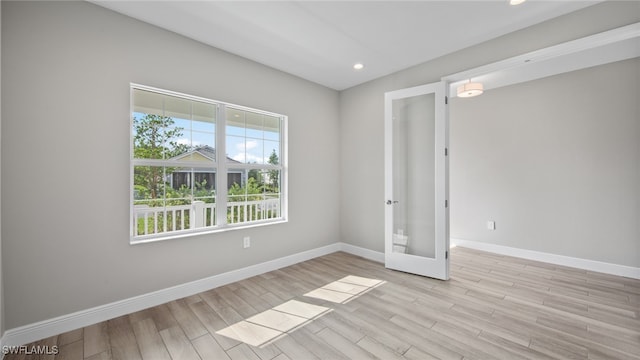 spare room featuring light hardwood / wood-style floors