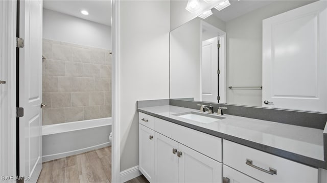 full bathroom featuring bathing tub / shower combination, vanity, toilet, and hardwood / wood-style floors