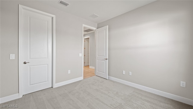 unfurnished bedroom featuring light colored carpet