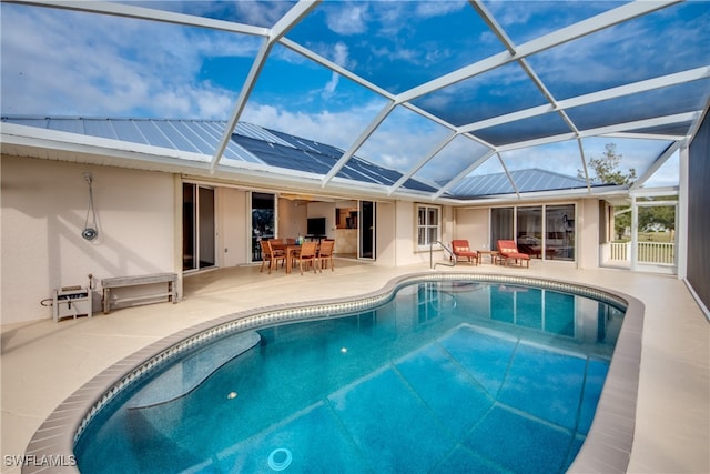 view of pool featuring a patio and glass enclosure