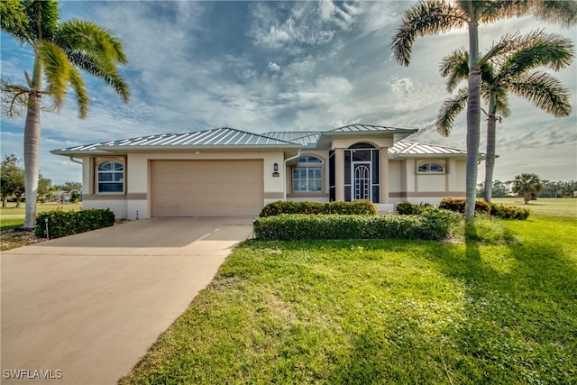 view of front of home with a garage and a front yard