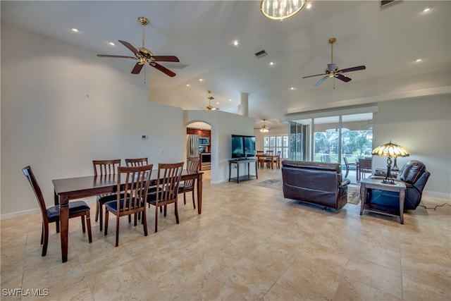 dining room with light tile patterned flooring, high vaulted ceiling, and ceiling fan