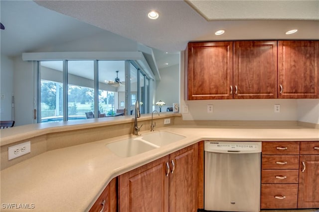 kitchen with light countertops, stainless steel dishwasher, brown cabinetry, and a sink