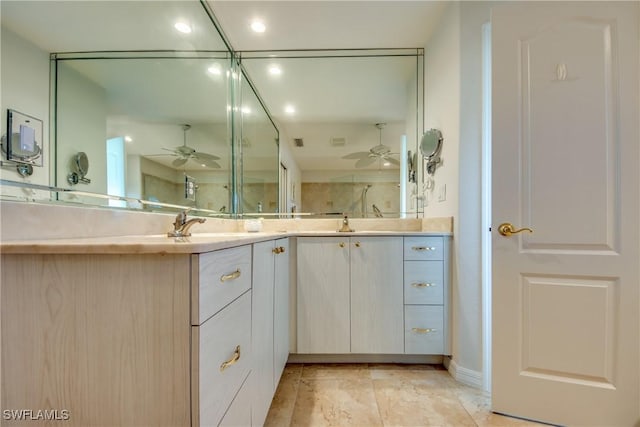 full bath with double vanity, a sink, a ceiling fan, and a shower stall